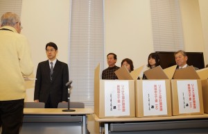 国交省職員に異議申立て書を手渡す市民団体メンバー（左）。（写真／樫田秀樹）