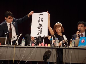 東京地裁の判決後、記者会見で「一部無罪」を掲げるろくでなし子さん（右から２人目）。（撮影／本誌取材班）